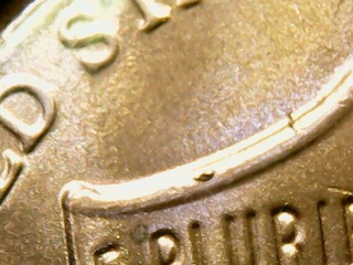 2018 penny BIE die chip error showing raised lump between B and E in LIBERTY